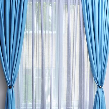 Blue curtains with white sheers