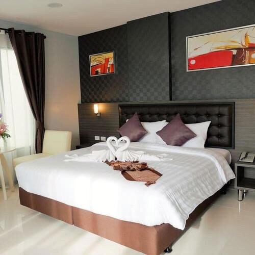 Bedroom with a dark feature wallpaper