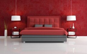 Red feature wallpaper in a bedroom
